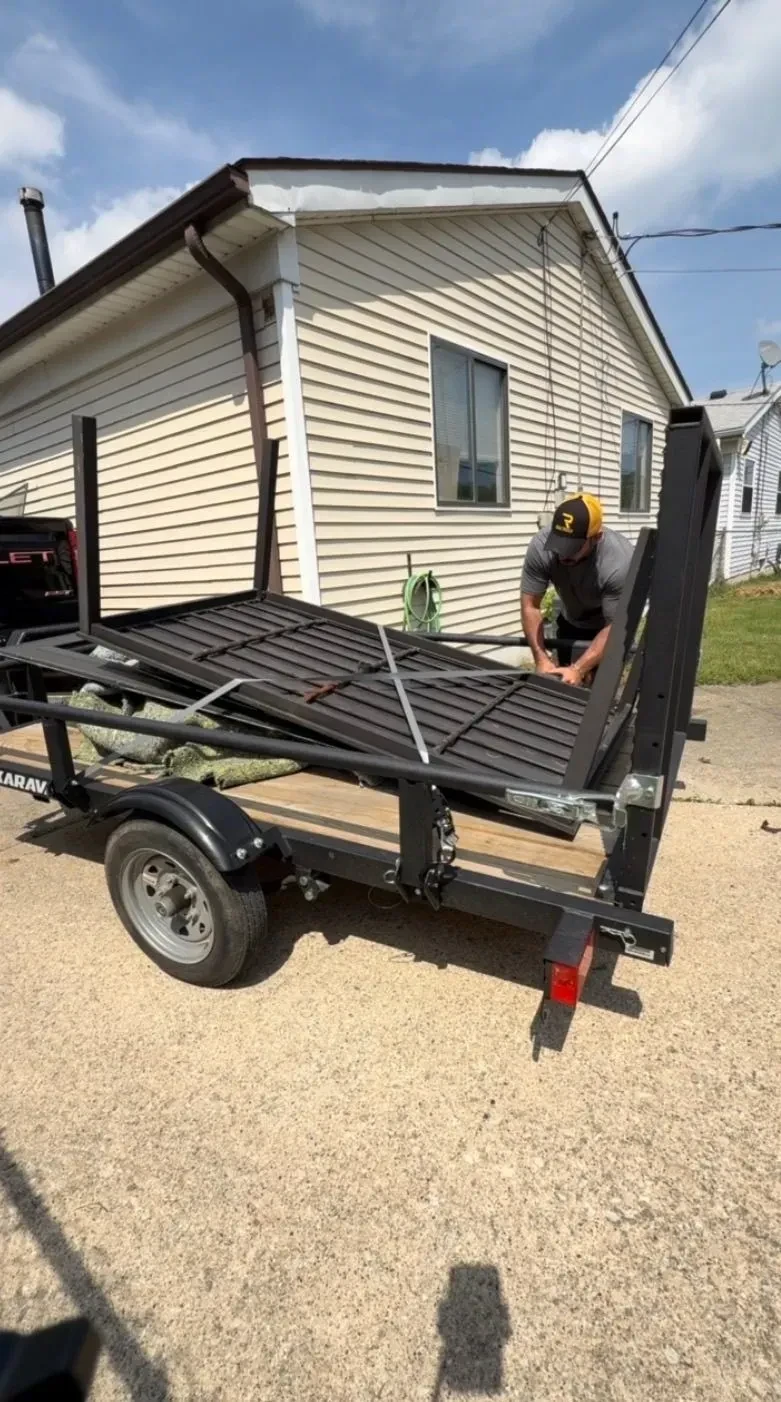 Household items loaded into a Demohaulic trailer during a junk removal project in Roseville Michigan