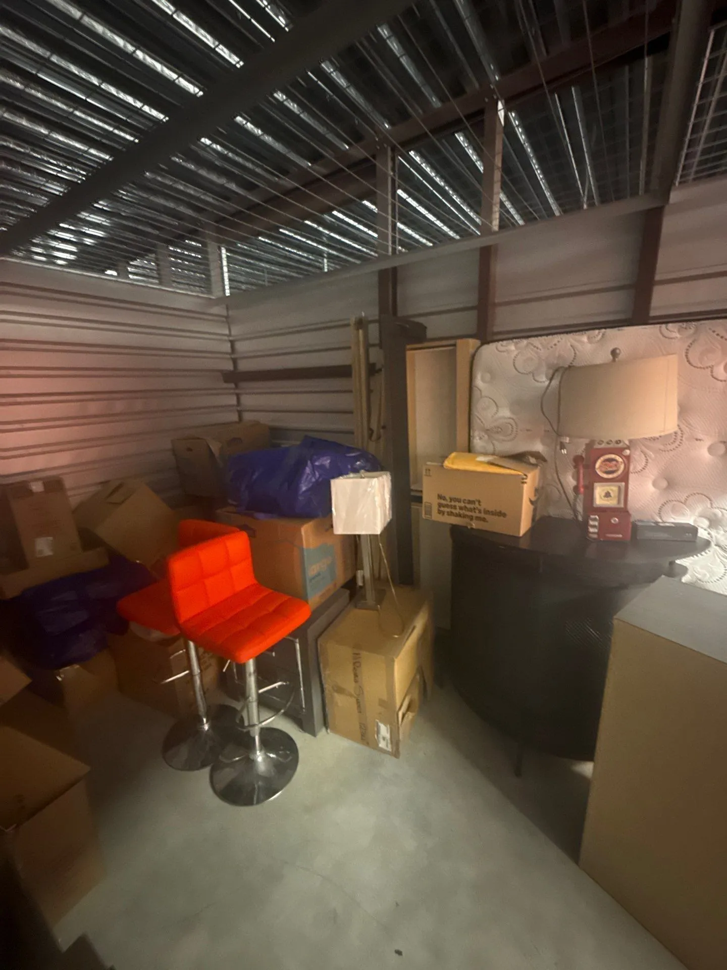 Furniture, boxes and household belongings crowding the unit interior before the cleanout