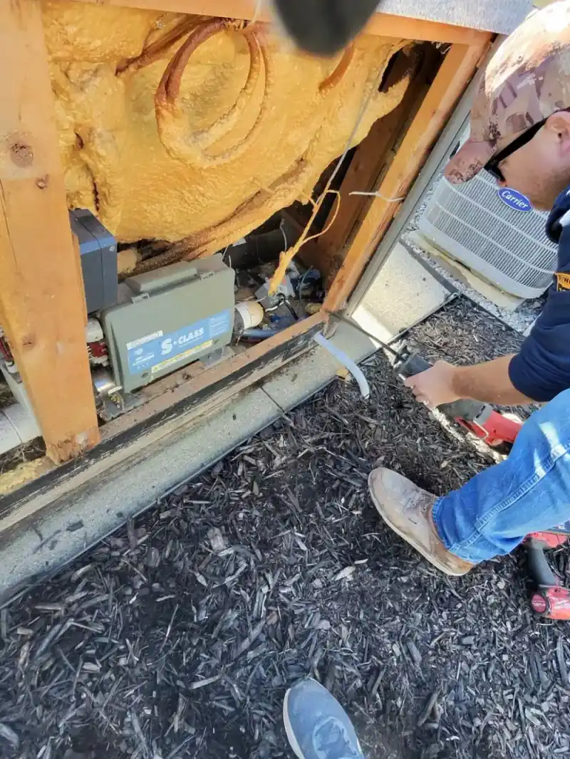 Crew member working to break down hot tub components
