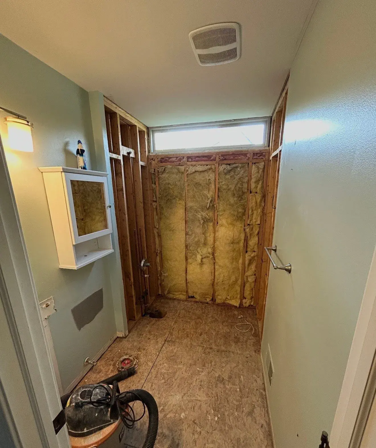 Waterford bathroom after demolition with exposed framing and subfloor, ready for preparation